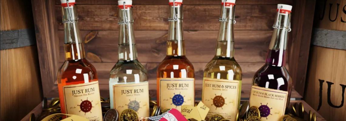 Five Just Rum bottles of different varieties sits in a bed of award medals.